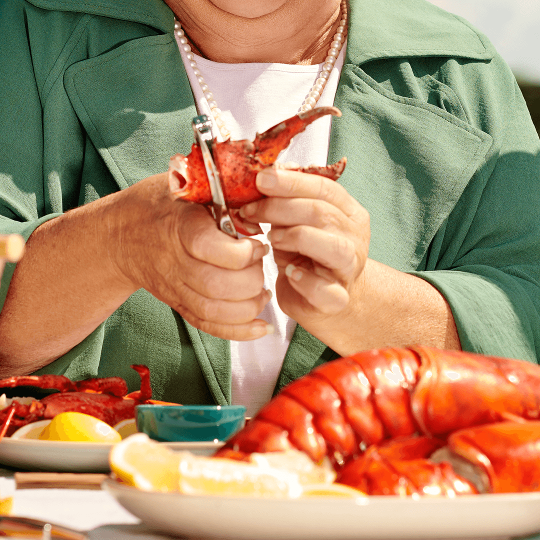 Person breaking down a lobster claw