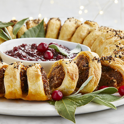 Sausage roll holiday wreath with onion cranberry chutney