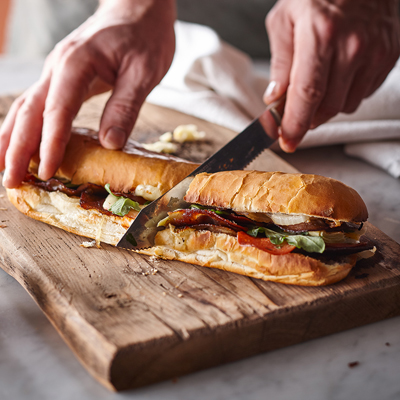 Submarine sandwiches with spicy pepperoni, artichoke and caramelized onion